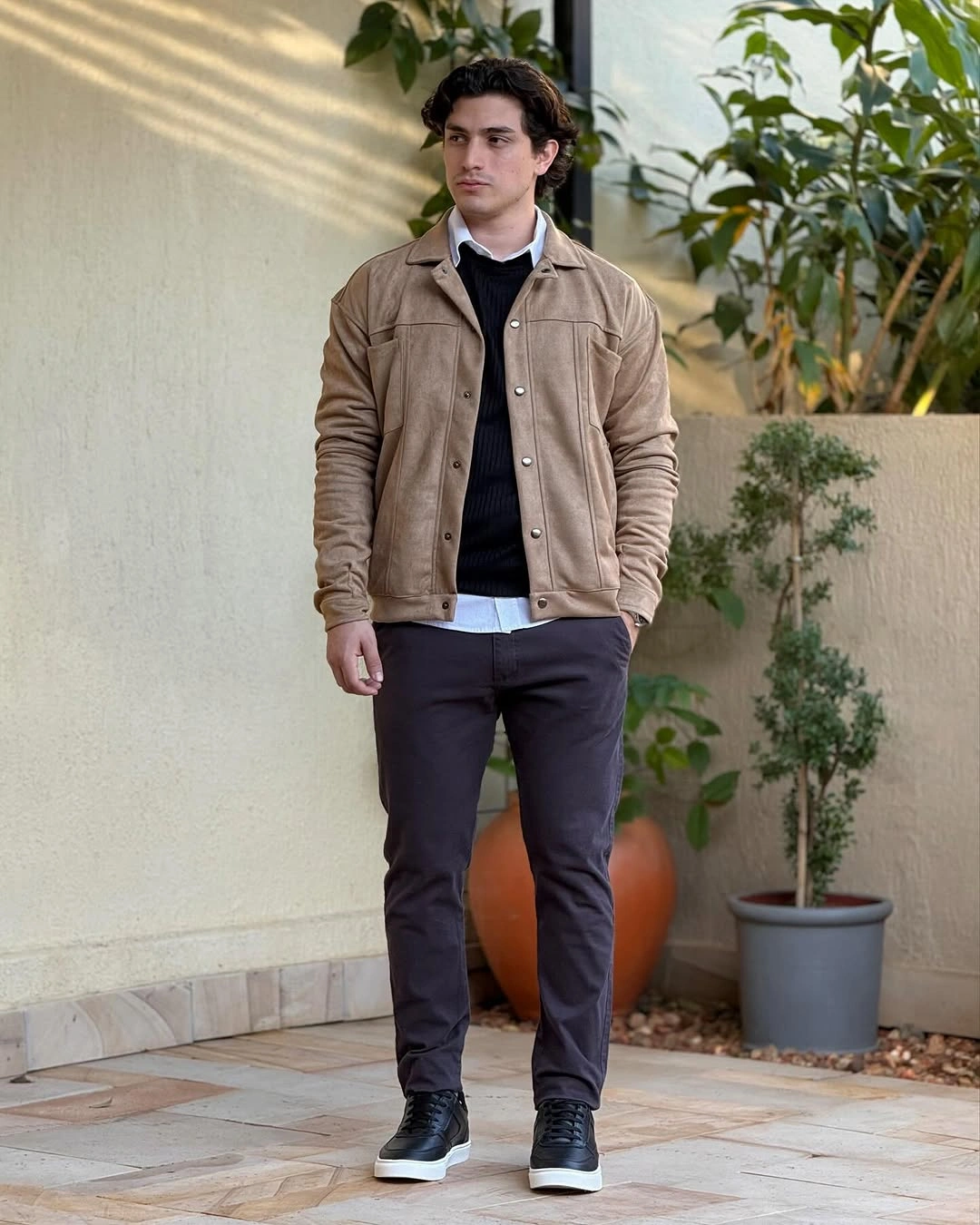 Tan overshirt with dark layers jeans and black sneakers