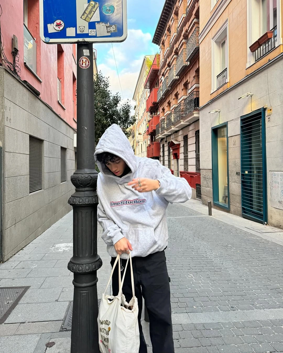 Gray hoodie with black outer layer trousers and tote