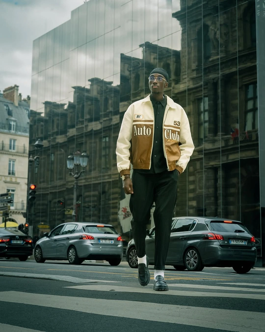 Brown and cream varsity jacket with black trousers
