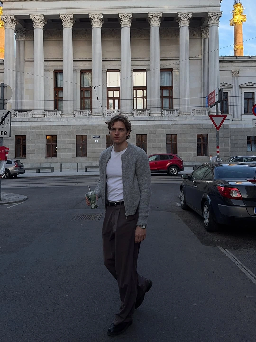 Gray cardigan over white T-shirt with pleated trousers