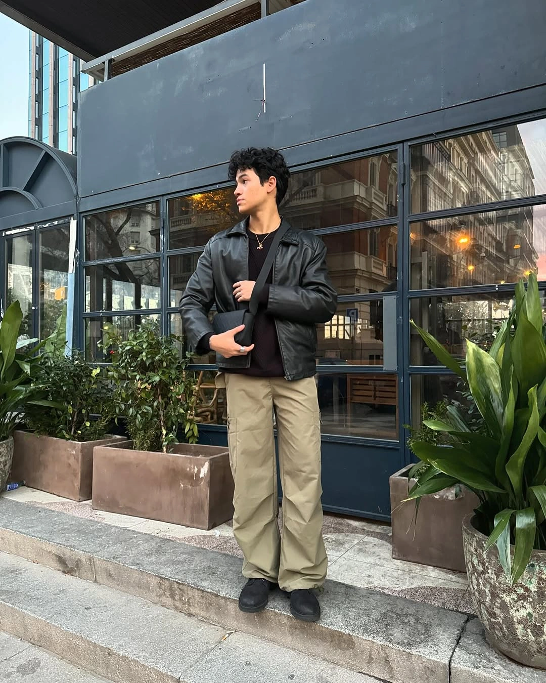 Black bomber jacket with khaki straight trousers