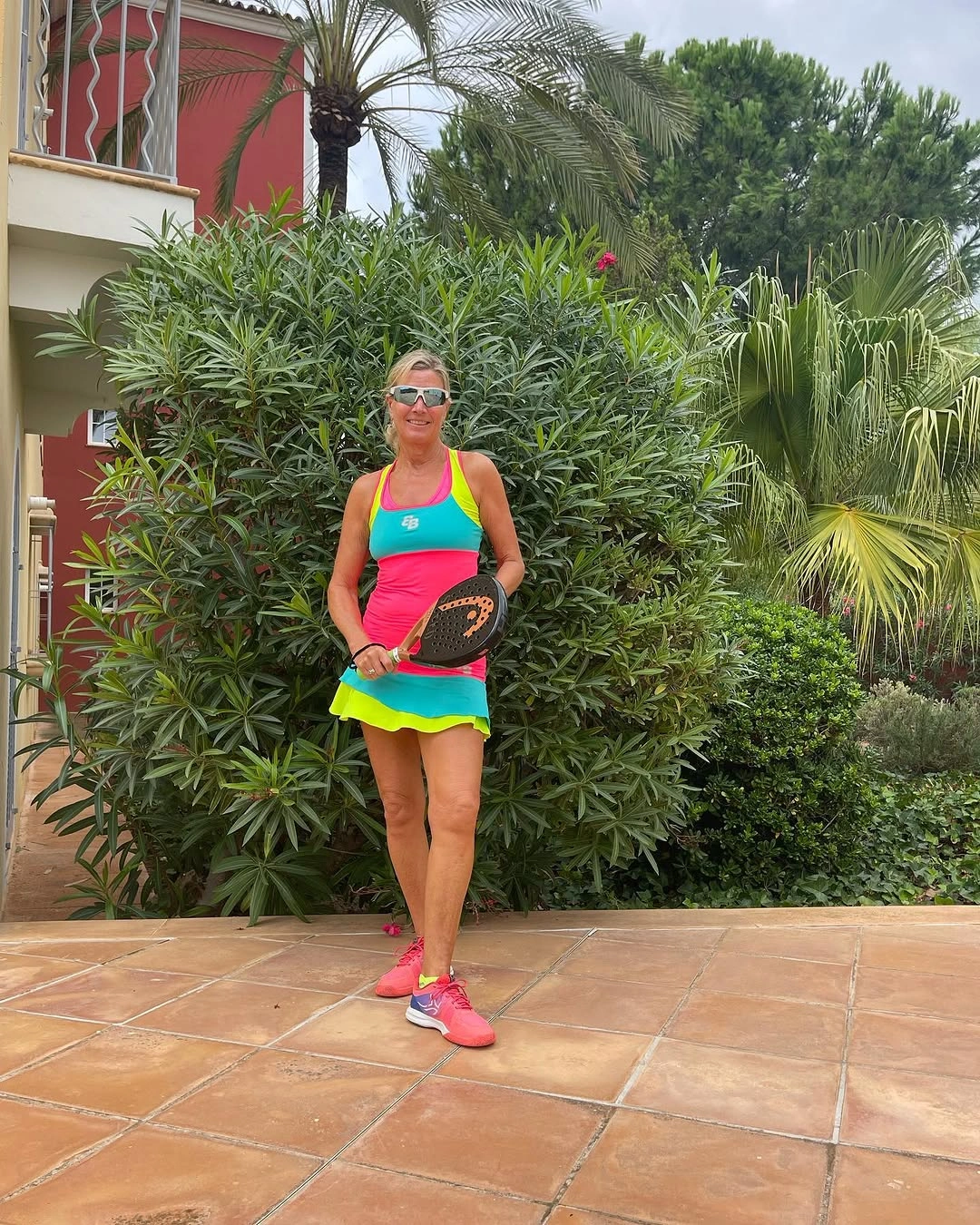 Pink and neon green ruffled athletic dress with pink shoes
