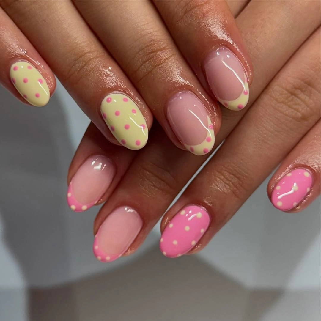 Medium pink oval nails with pale green tips and clustered pink dots