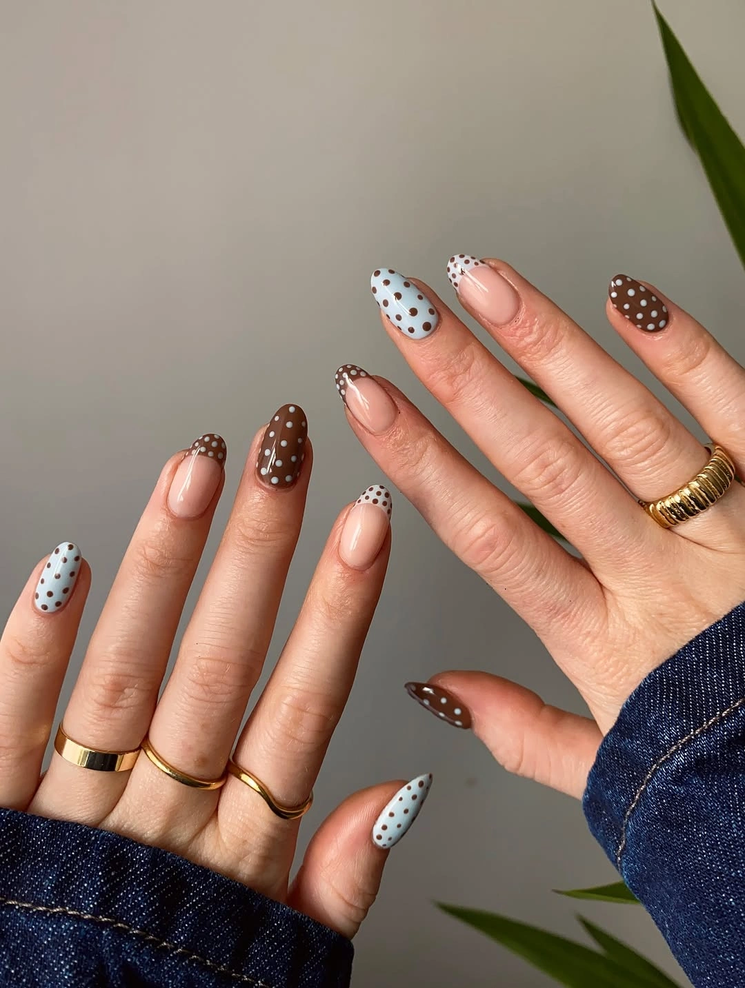 Nude almond nails with white brown and pale blue polka dot accents
