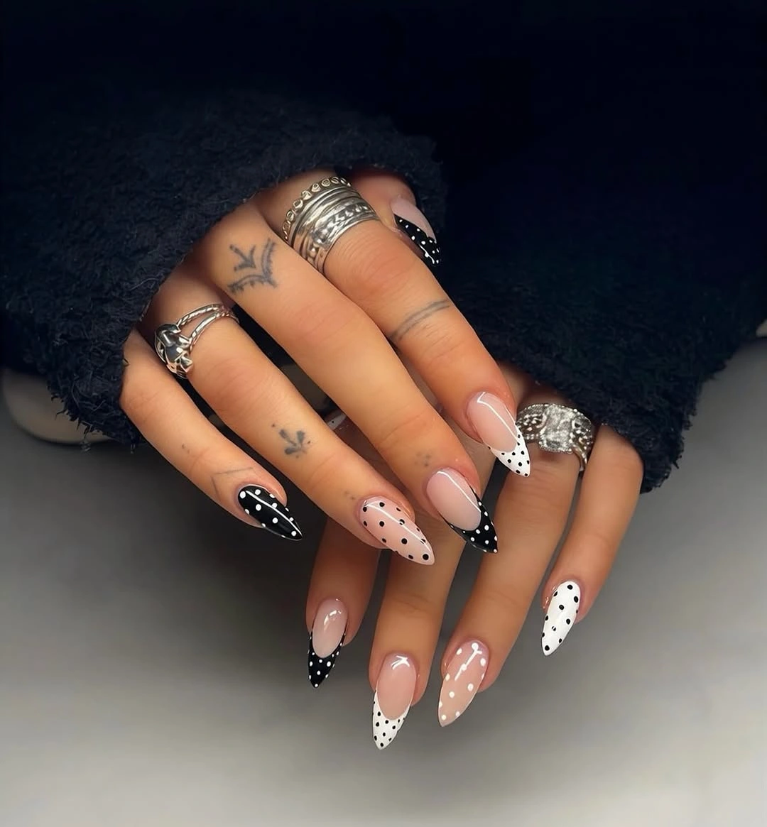 Long nude stiletto nails with black-and-white dotted French tips