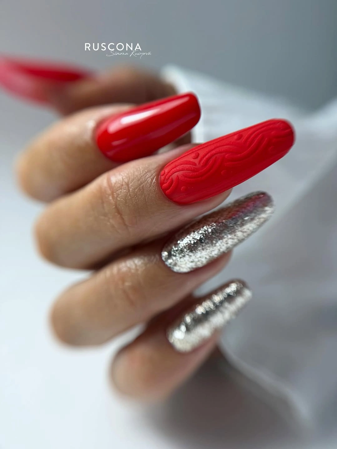 Very long red and silver nails with tonal wavy texture