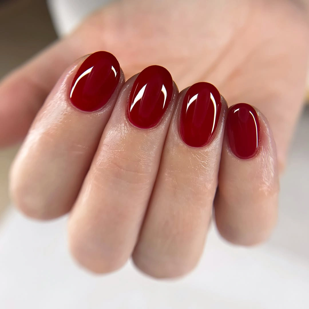 Short oval nails with uniform glossy deep crimson red
