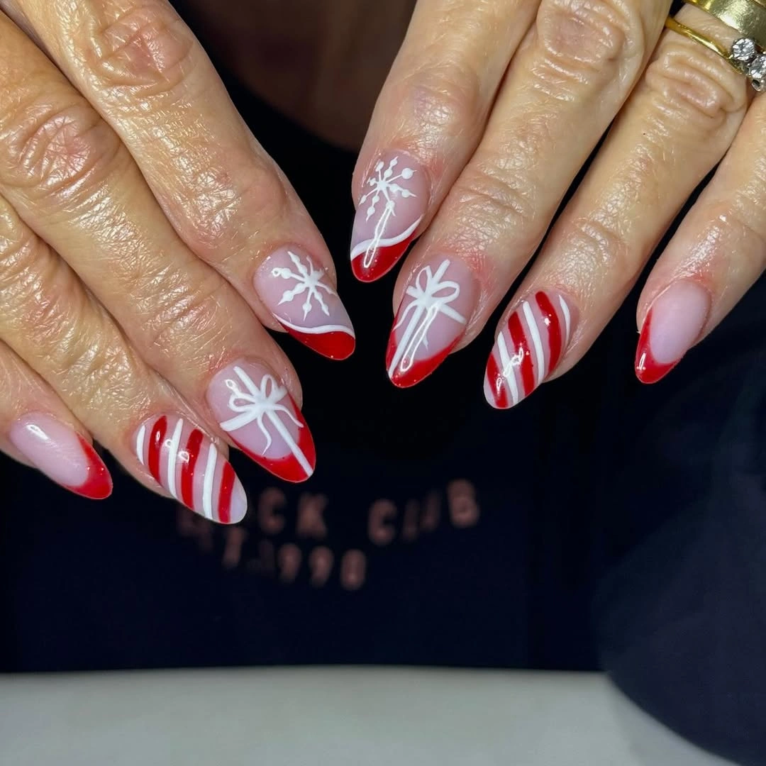 Long almond pink nails with red tips white bows and stripes