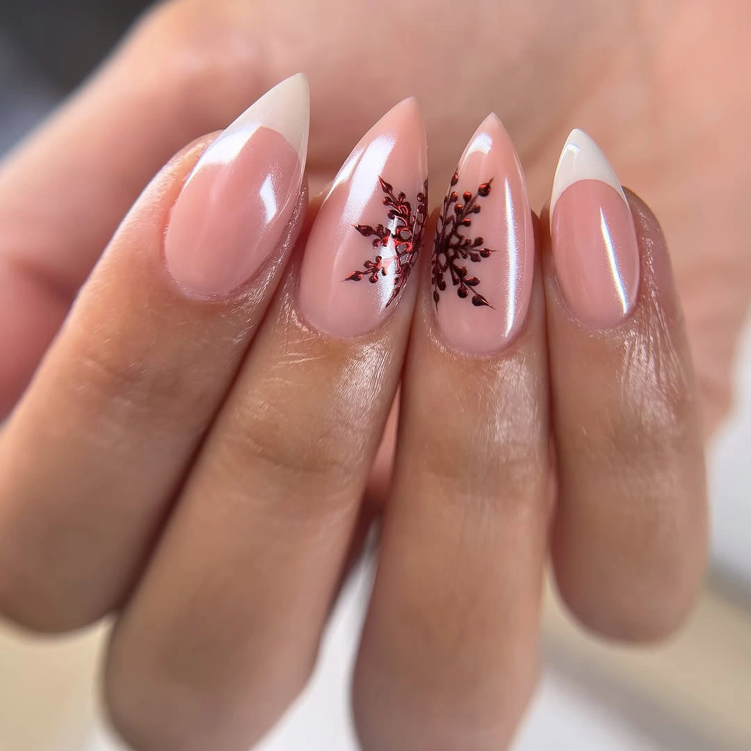 Long pale pink almond nails with burgundy branching motifs