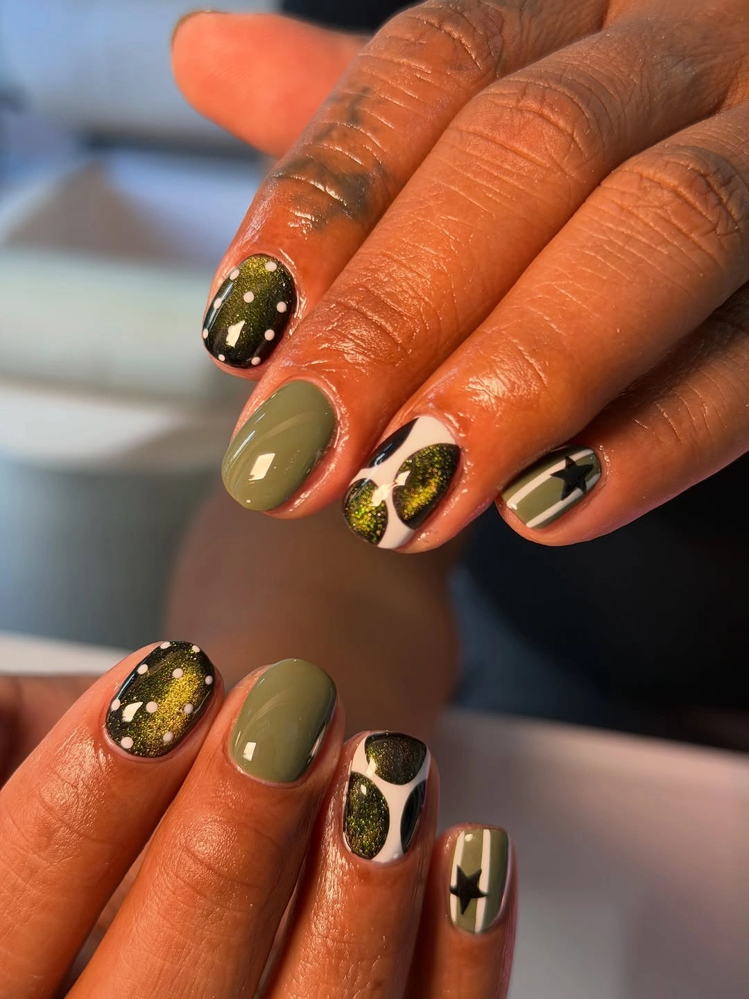 Olive green black and white short nails with stars and dots