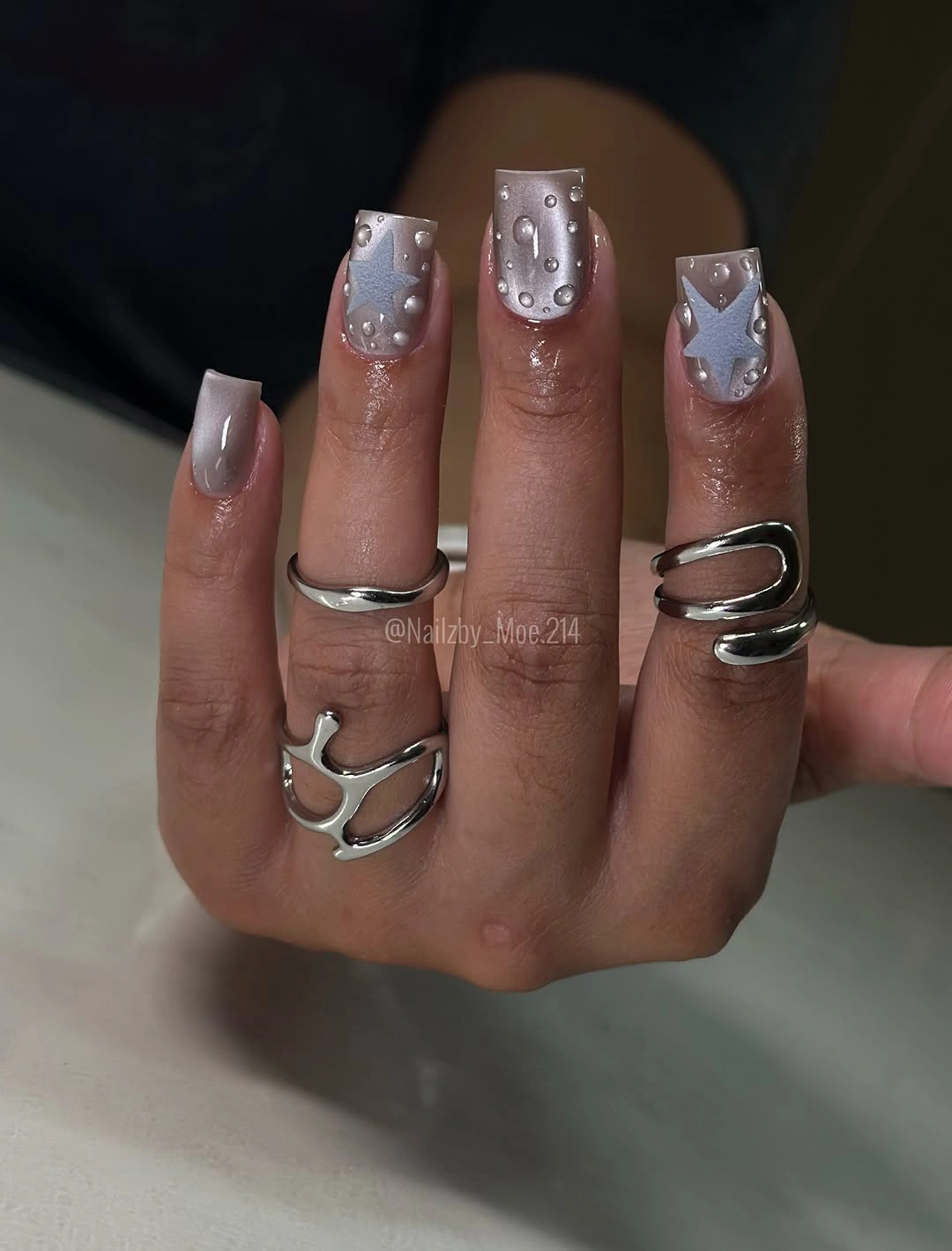 Square silver nails with raised dots and star accents