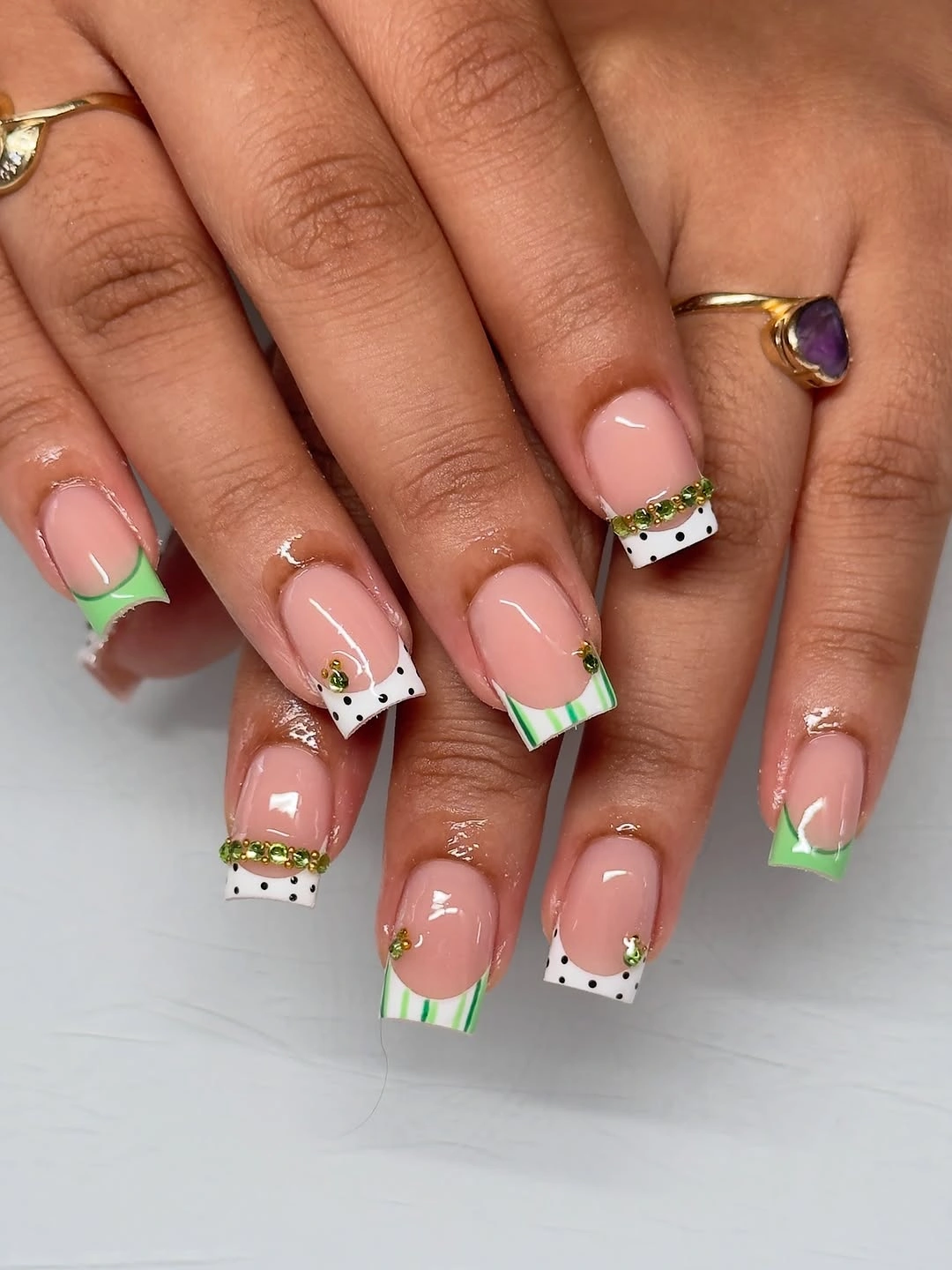 Nude square nails with green and white decorated tips