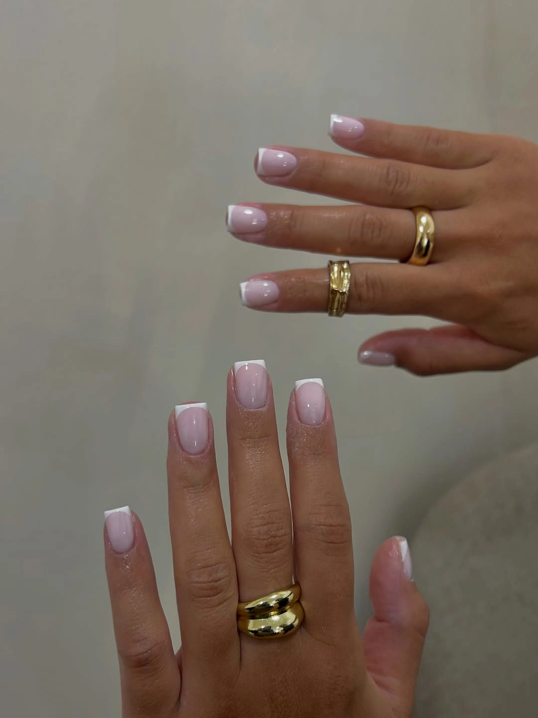 Glossy pink short square nails with white French tips
