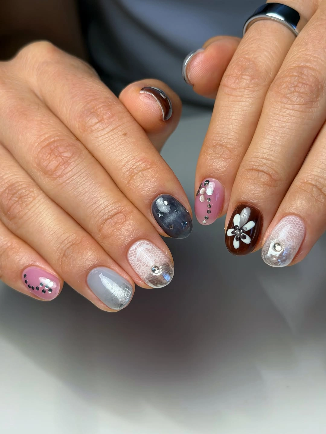 Mixed short nails with pink blue brown and raised accents