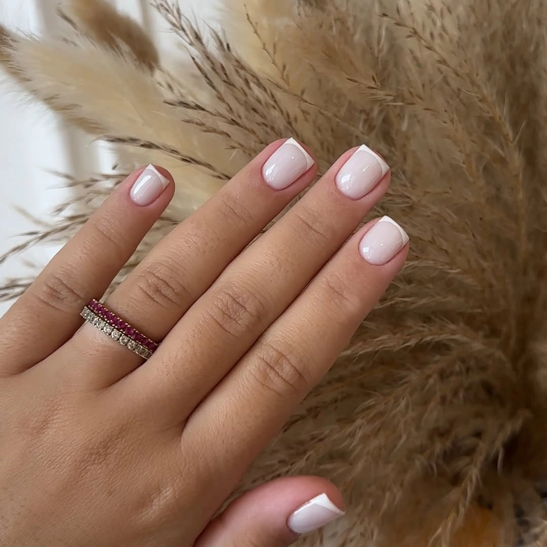 Glossy pink short square nails with soft white French tips