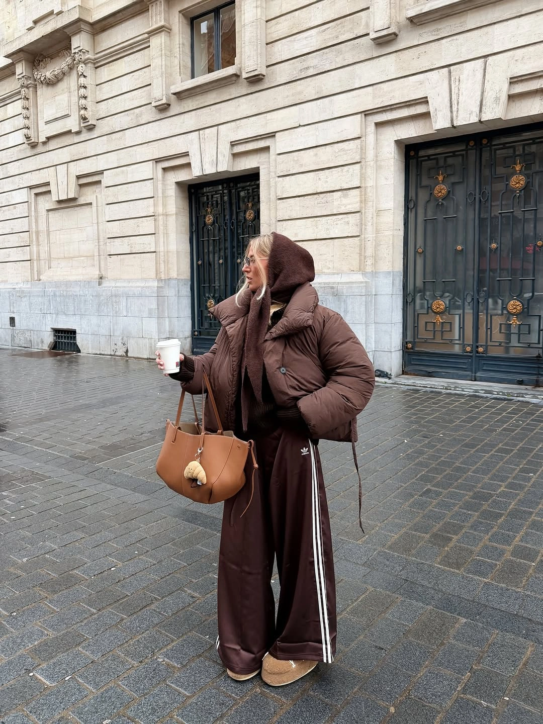 Brown puffer with brown leather-look pants and tan handbag