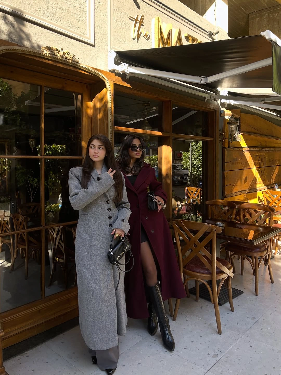 Light gray long coat near burgundy long coat and boots