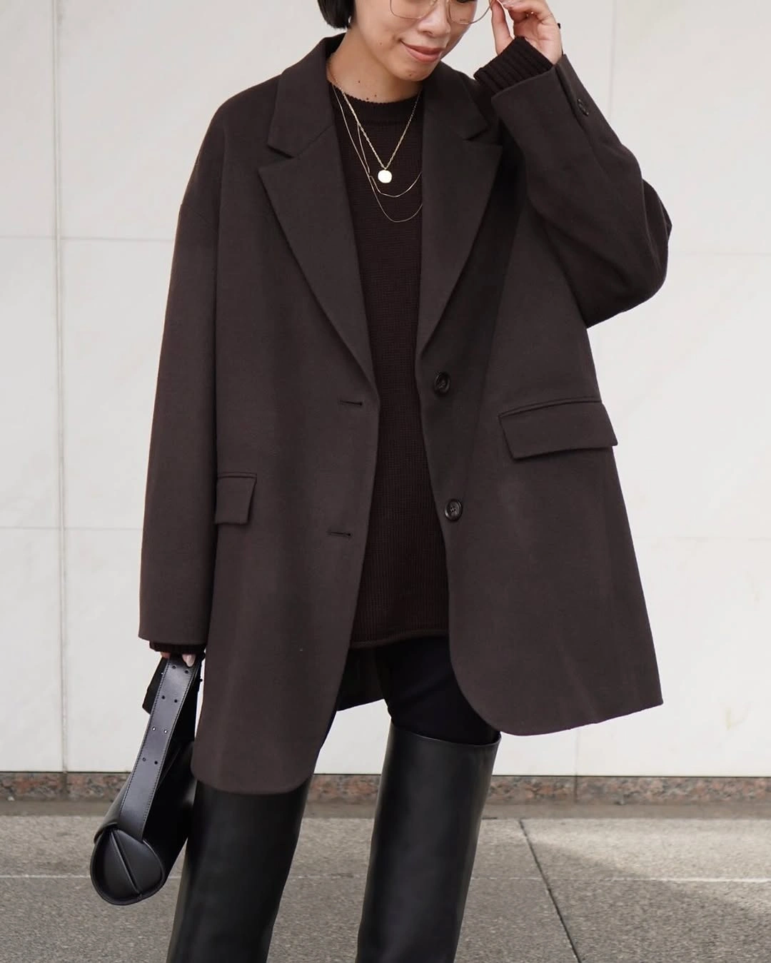 Dark brown blazer-style coat with black boots and handbag