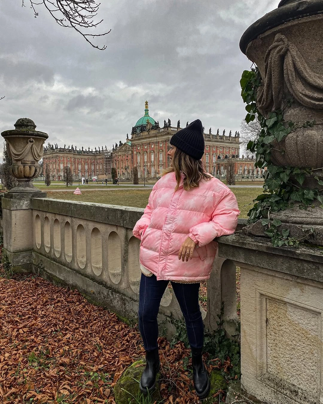 Short pink puffer with dark jeans and black boots