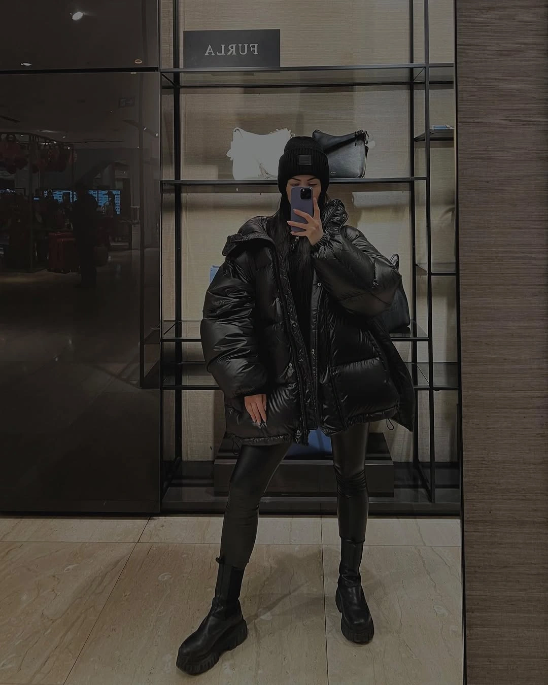 Oversized shiny black puffer with black leggings and boots