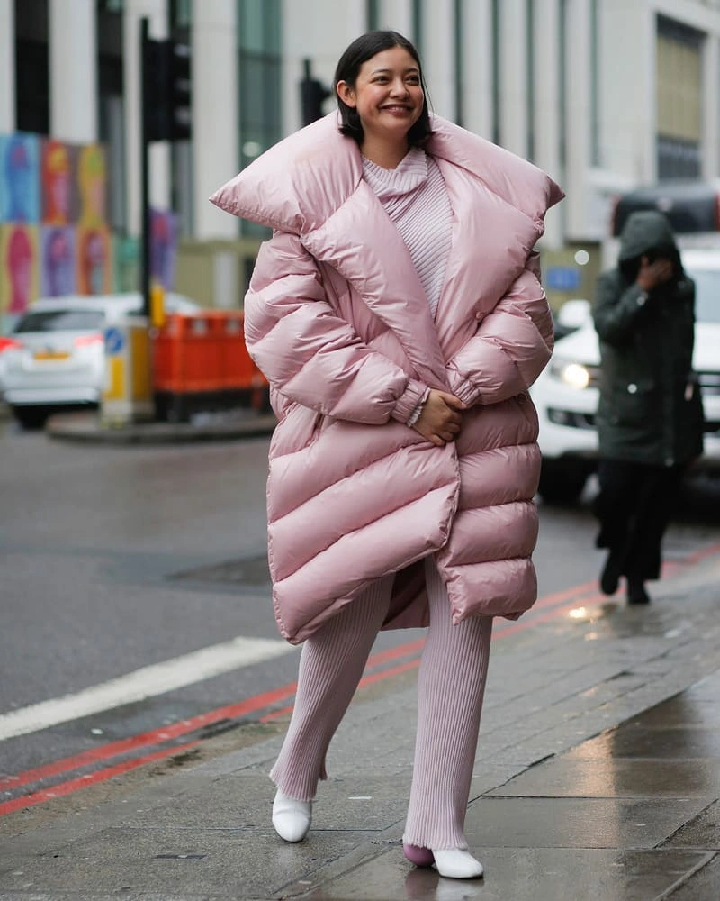 Pale pink long puffer with matching knit and white shoes