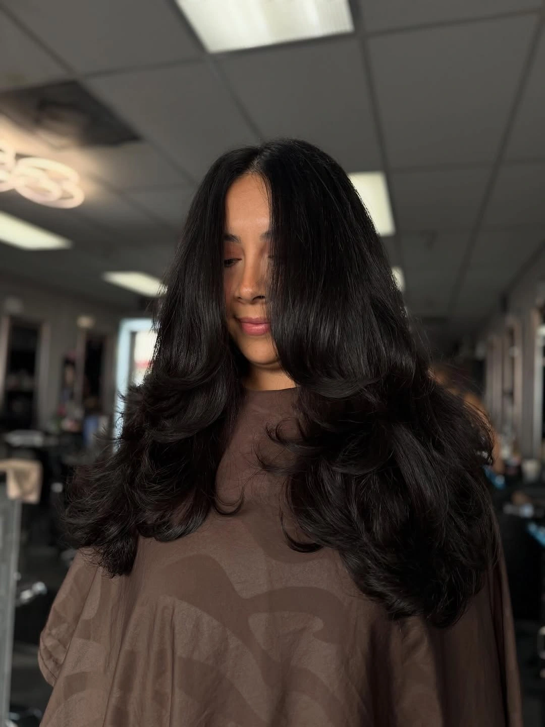 Very long dark layered hair with rounded curtain-like front frame