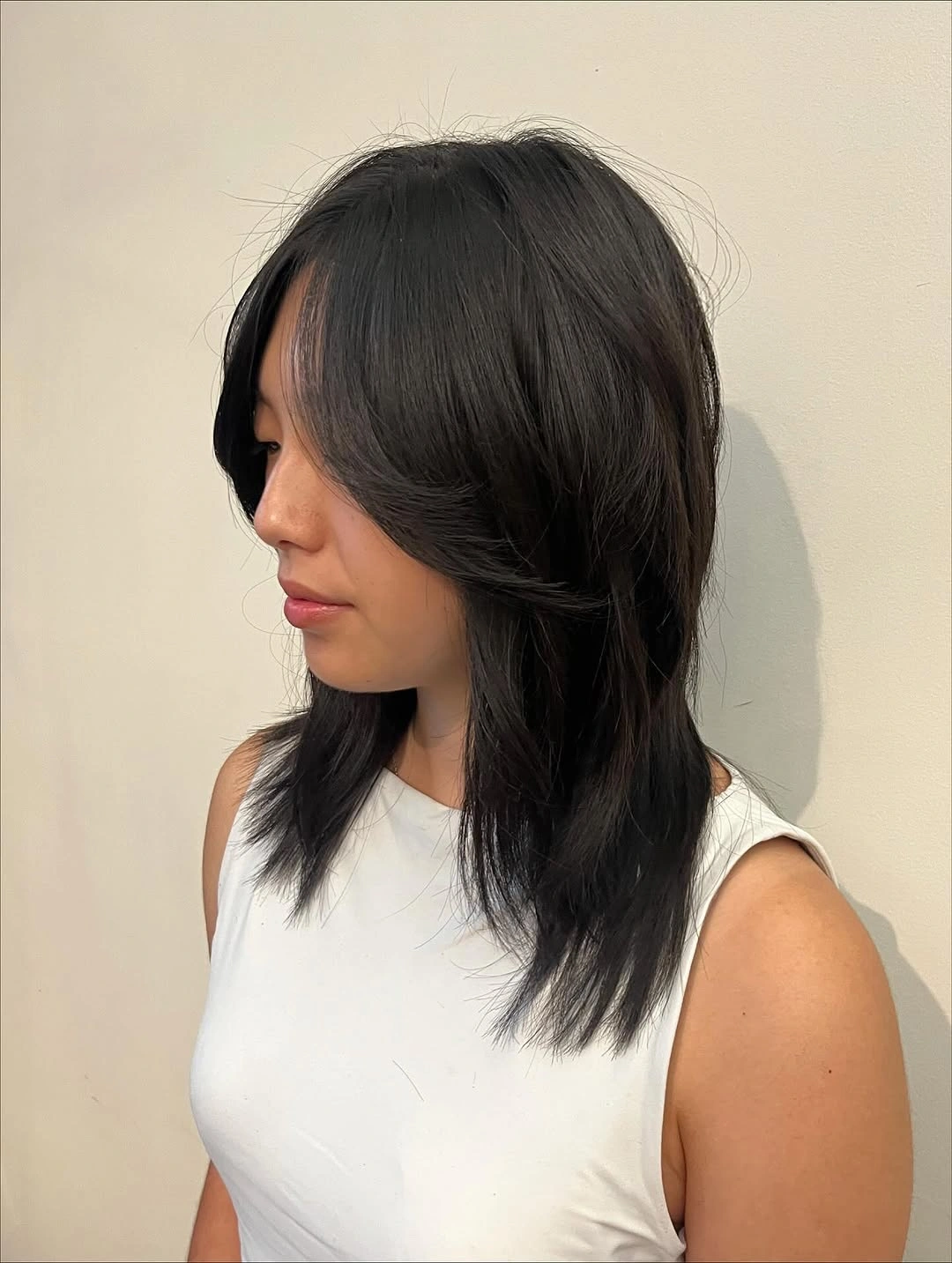 Medium black layered haircut with curtain-like front pieces