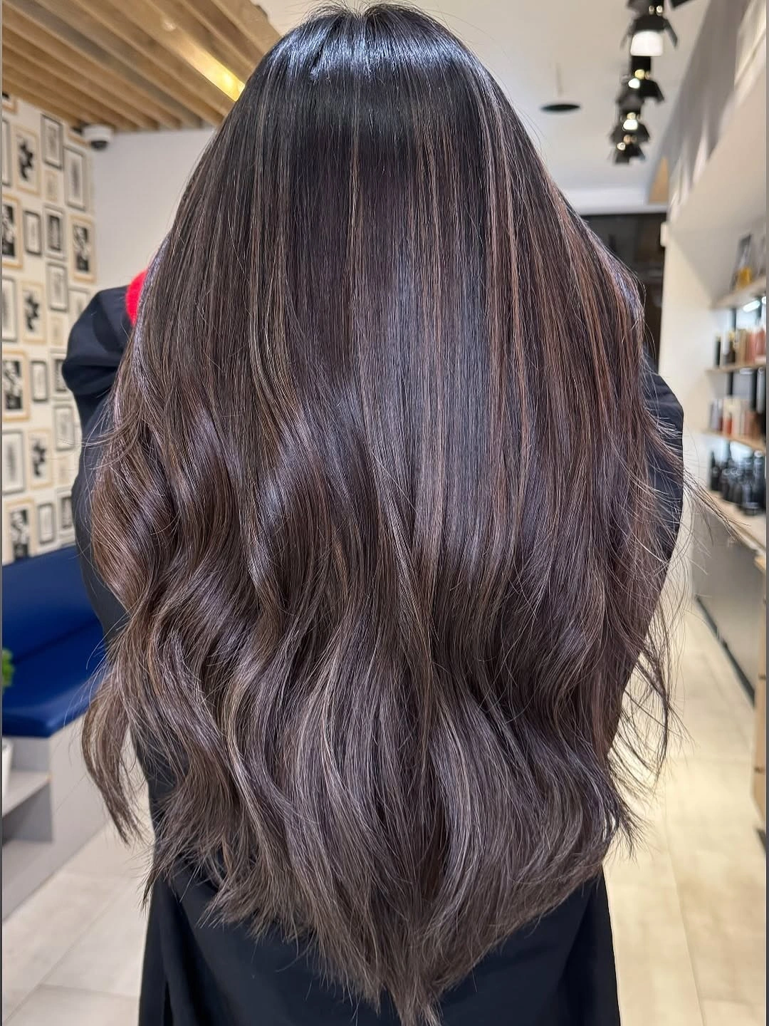 Rear view of very long ash-brown layered hair with subtle waves