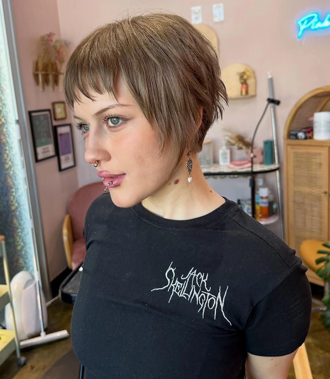 Short light brown pixie crop with tiny wispy bangs