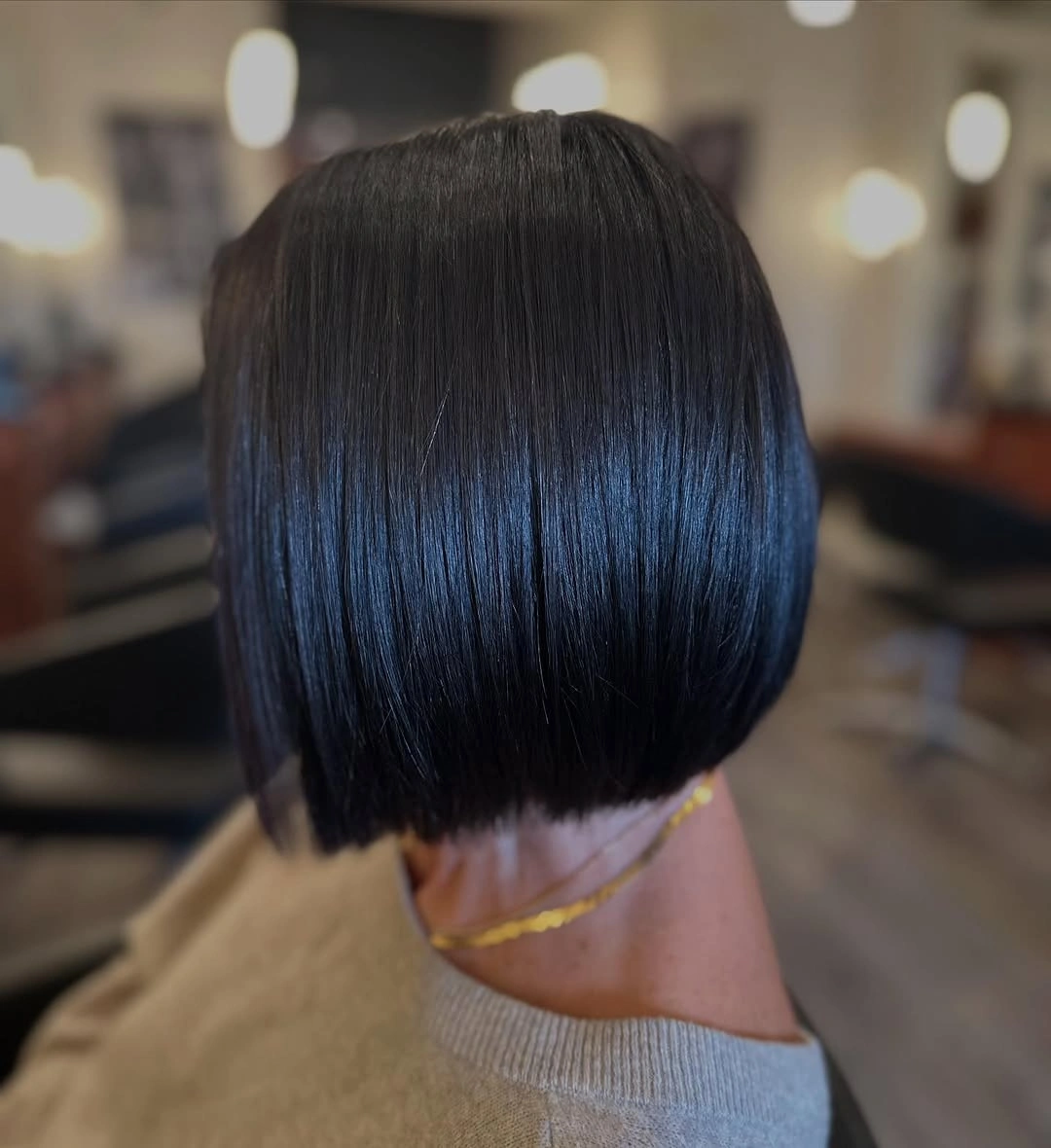 Rear view of short black blunt bob with straight nape line