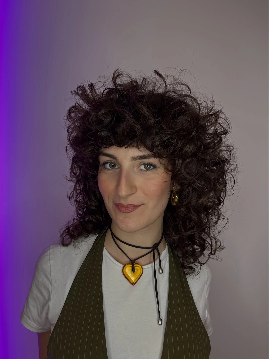 Medium curly shag-like haircut with short bangs and rounded sides