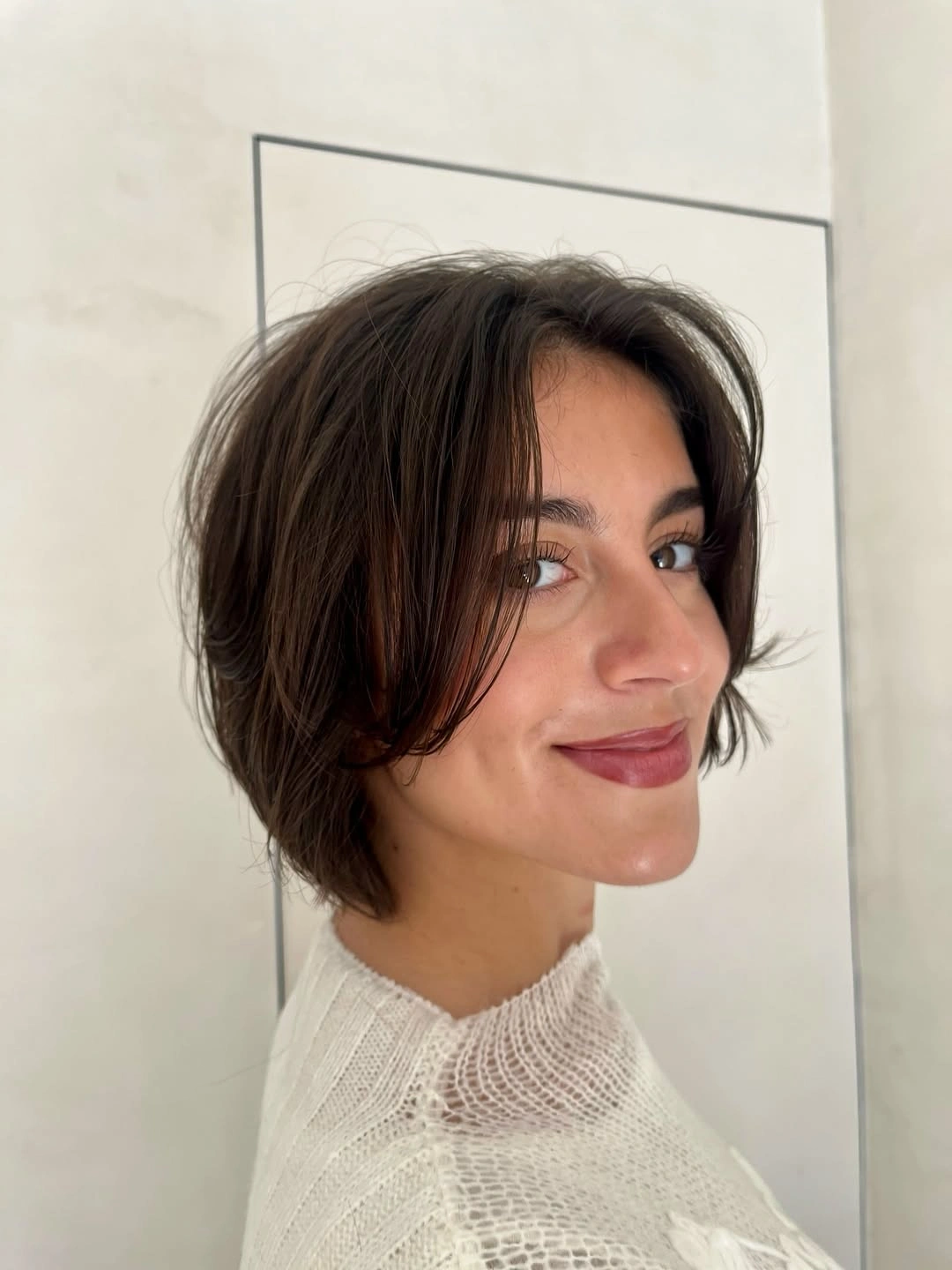 Short brown rounded bob with soft front pieces and compact nape