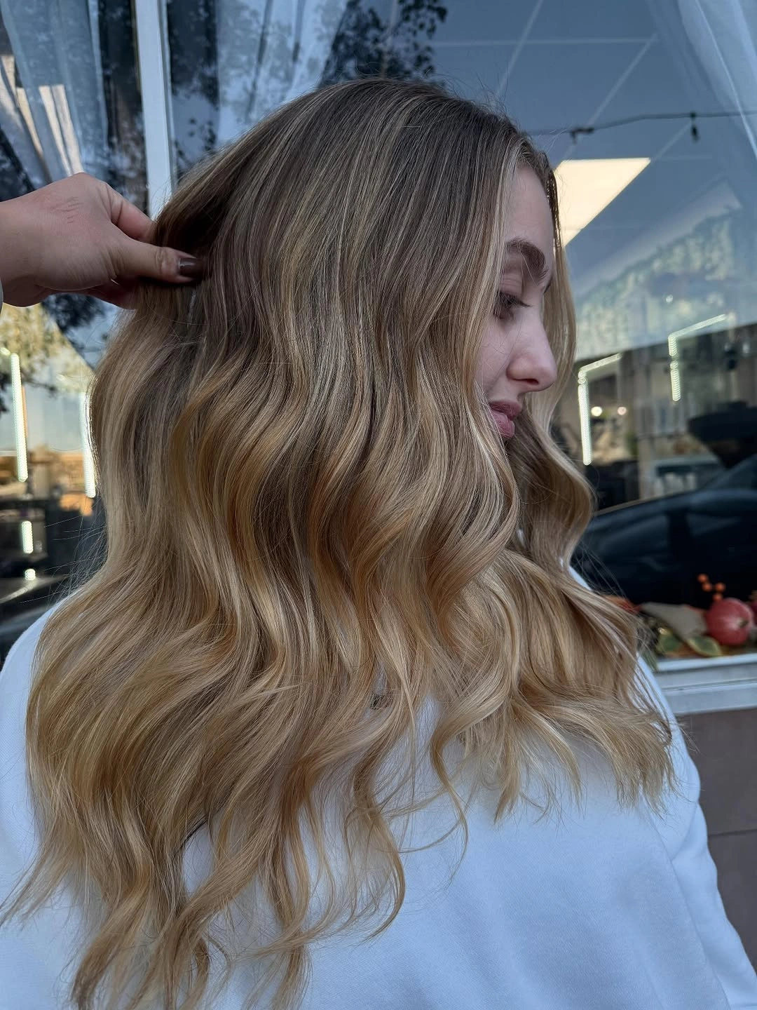 Long blonde wavy layered hair viewed from the side