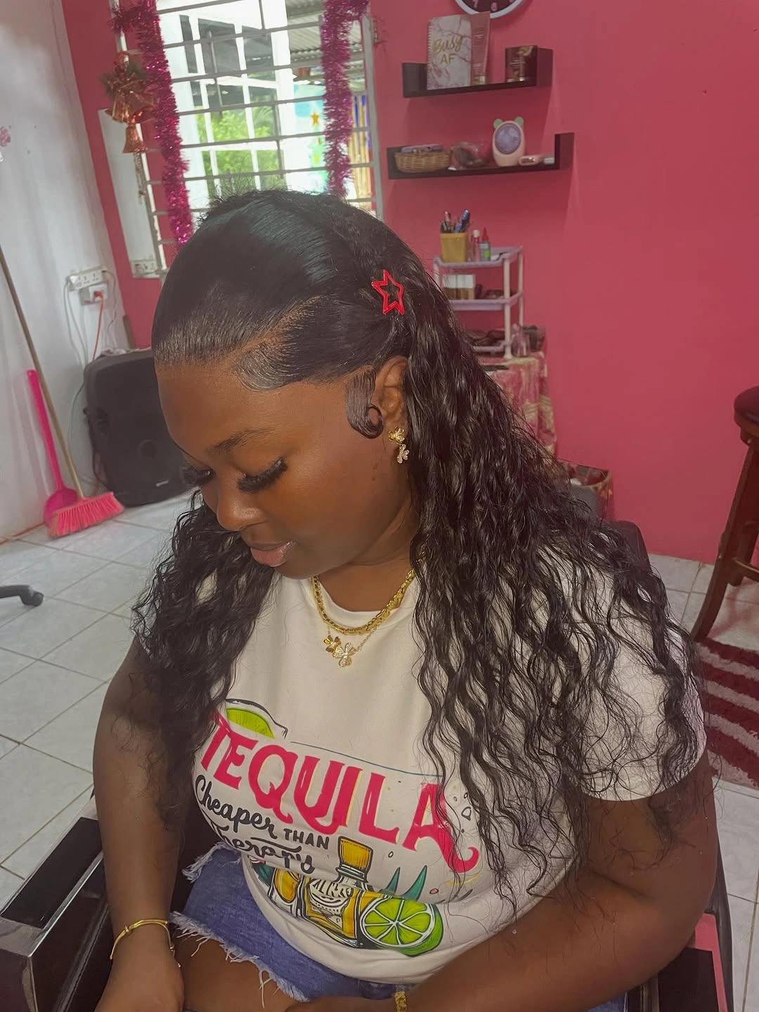 Long black waves with sleek swoop and red clips