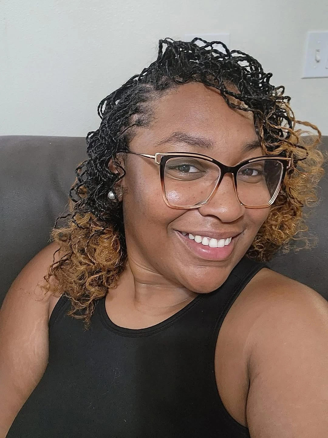 Short-to-medium black and honey-blonde curl-like pieces with glasses