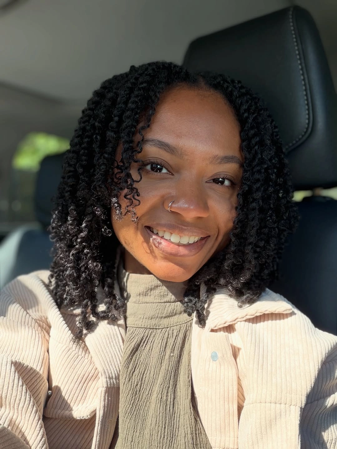 Short black curls with soft center part and rounded edge