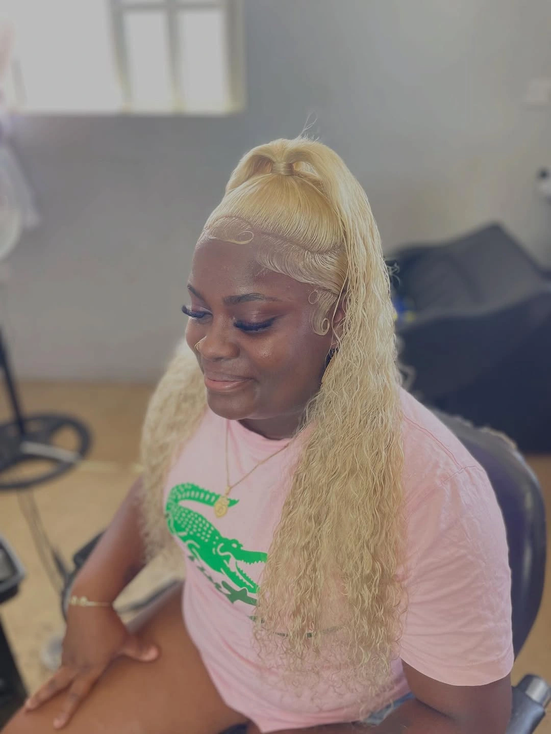 Long blonde waves with high ponytail and smooth hairline