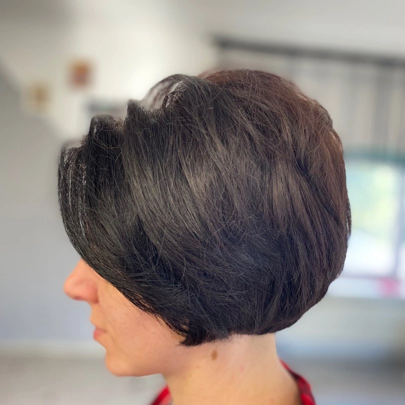 Rounded dark brunette bob with heavy side swept fringe