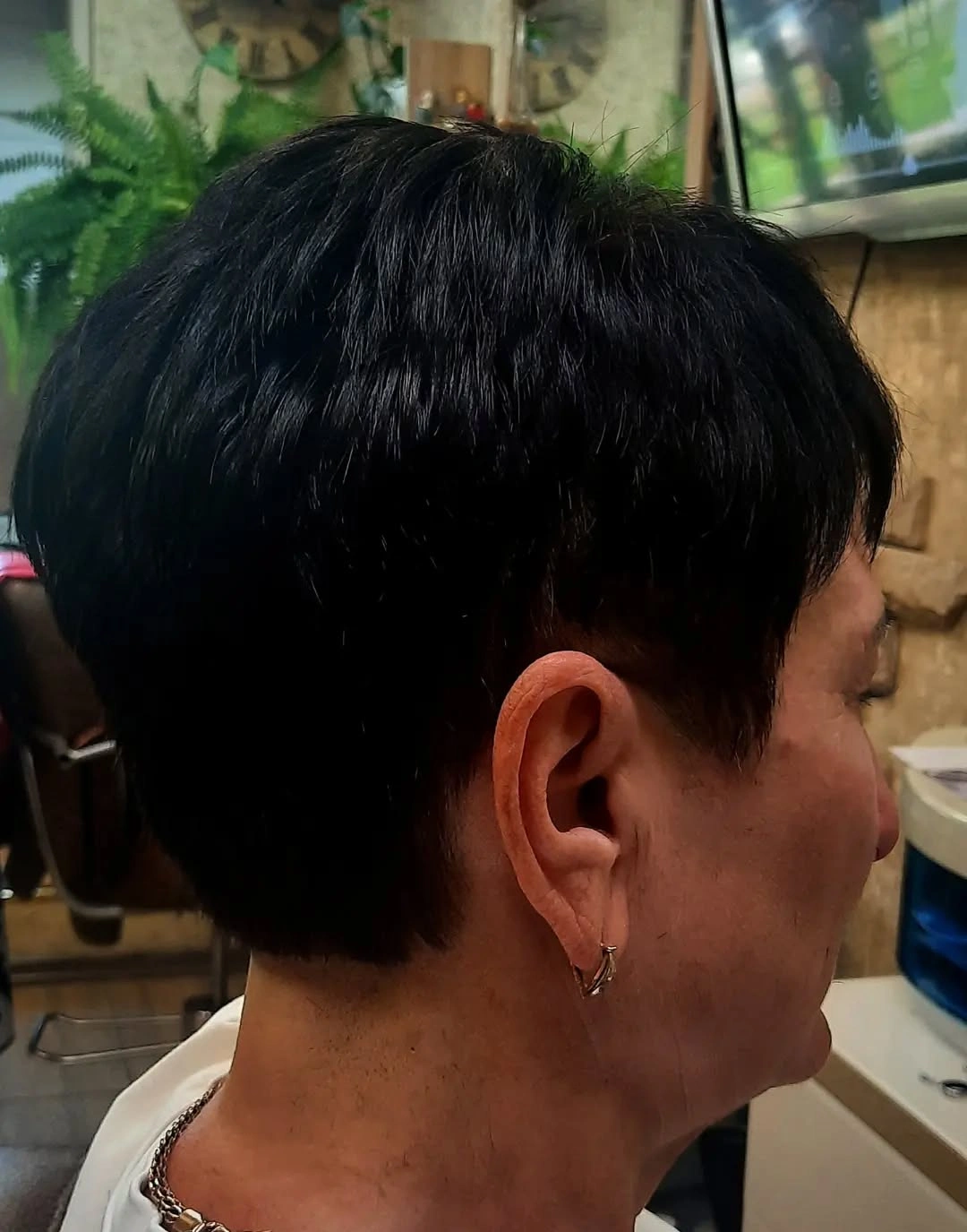 Black short pixie crop with rounded crown and tapered nape