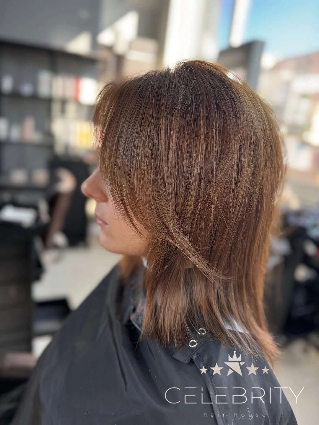 Medium warm brunette layered cut with swept front pieces