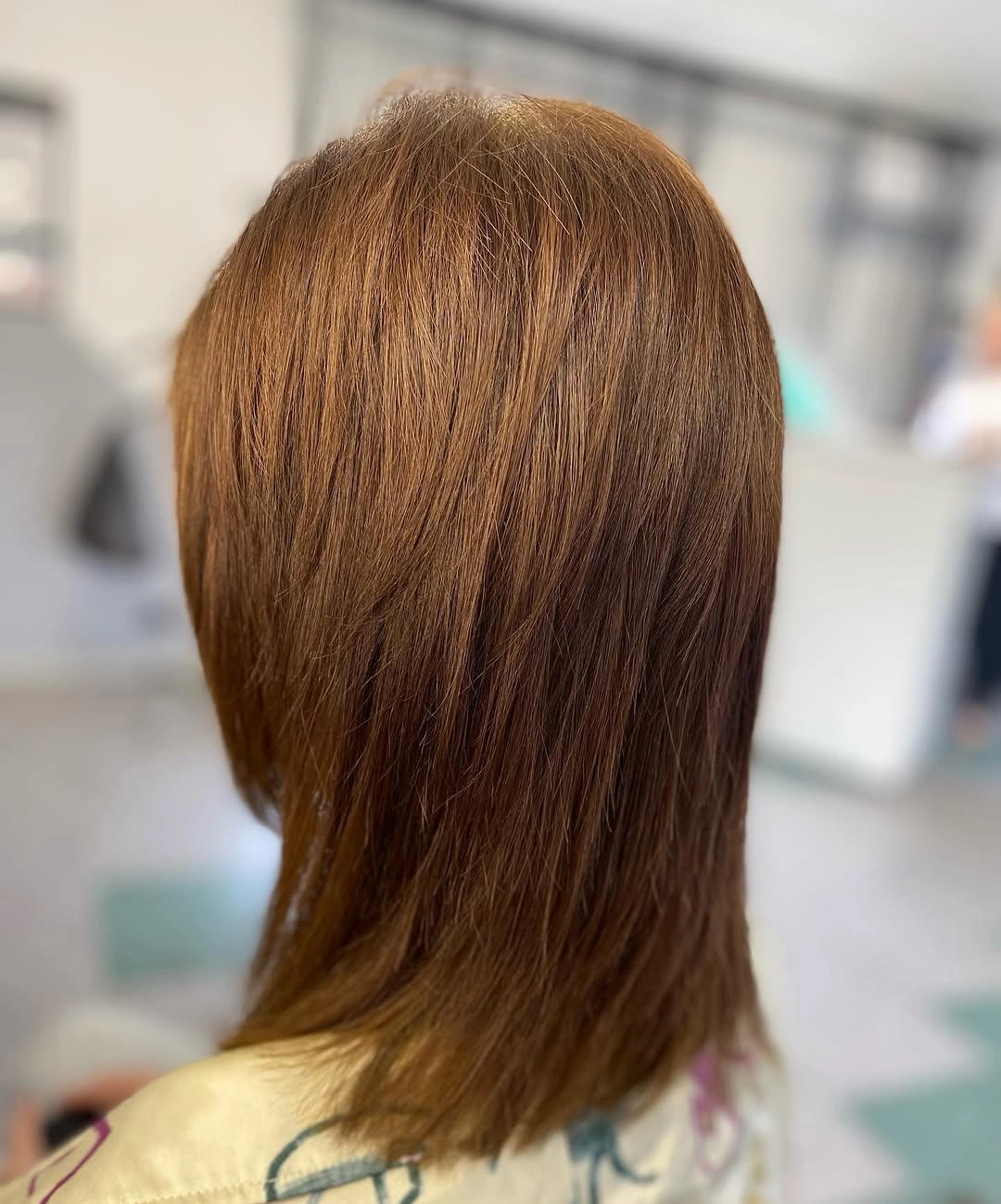 Warm brown mid-length layered cut with tapered lower ends