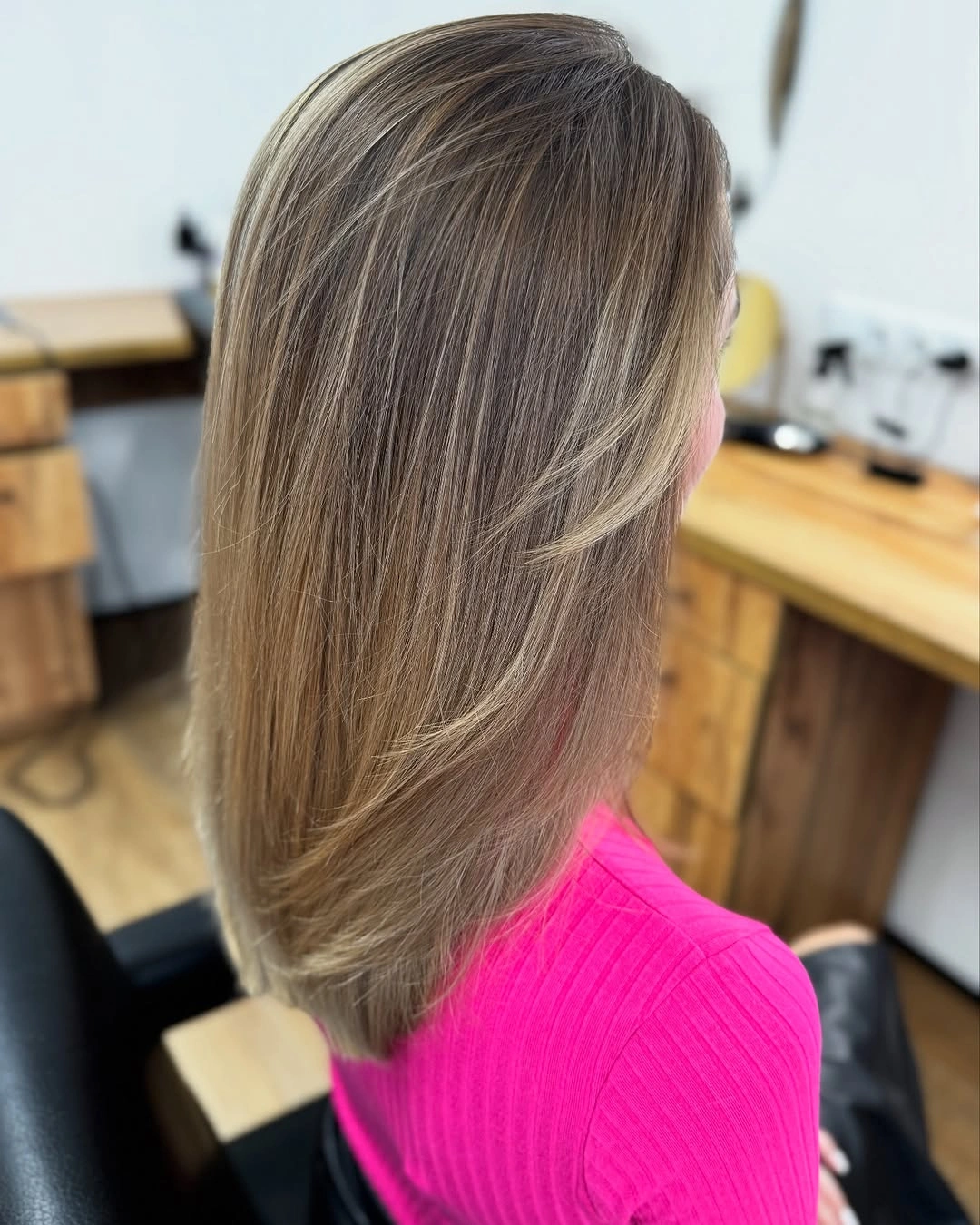 Medium long blonde brown hair with curved layered ends