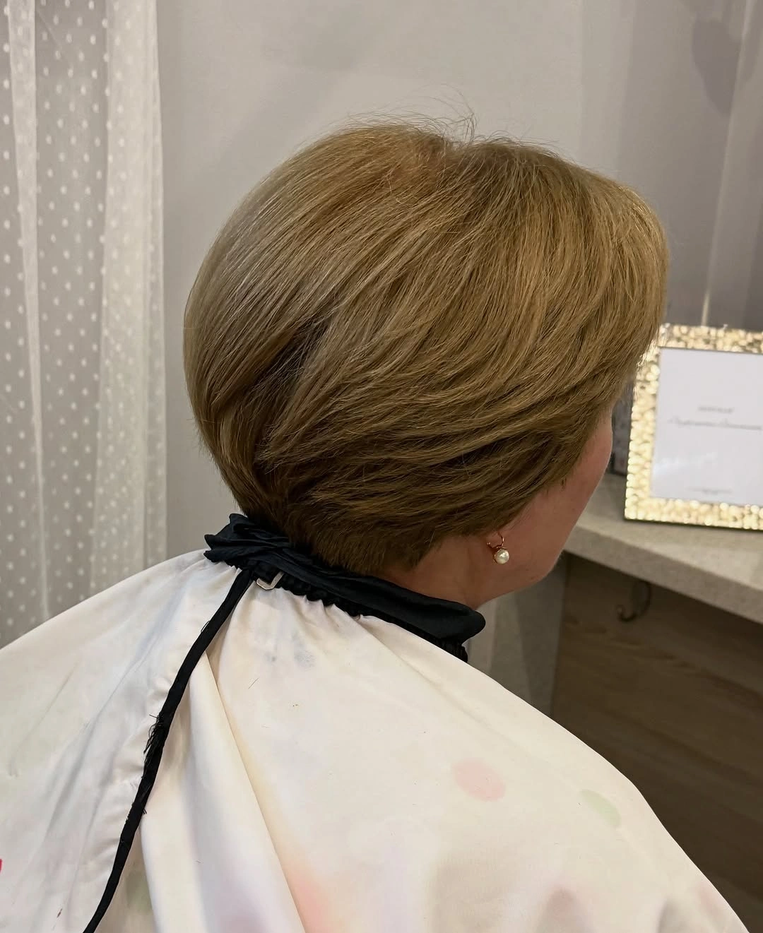 Warm highlighted layered short cut with rounded stacked-looking back