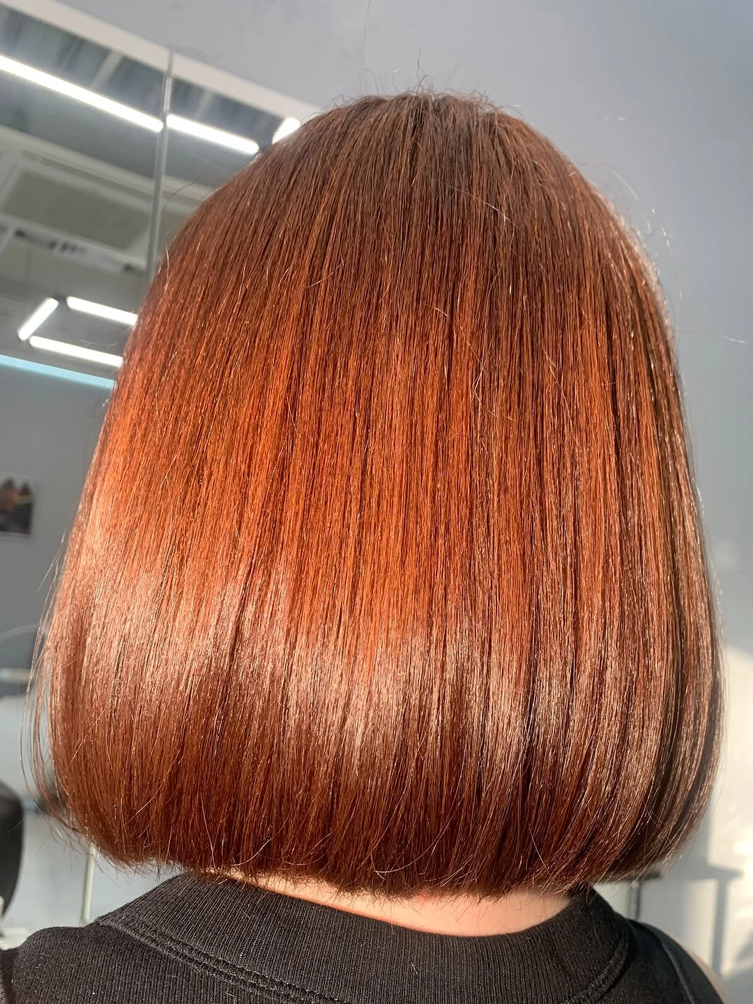 Smooth copper bob from back with blunt rounded hem