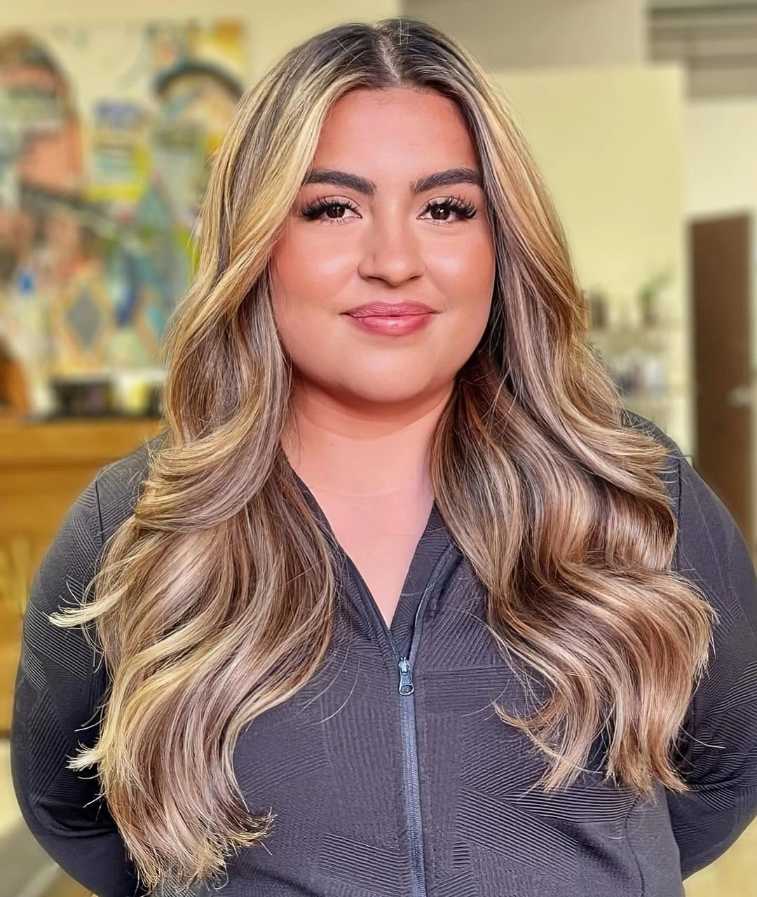 Long blonde hair with large waves and layered lower lengths