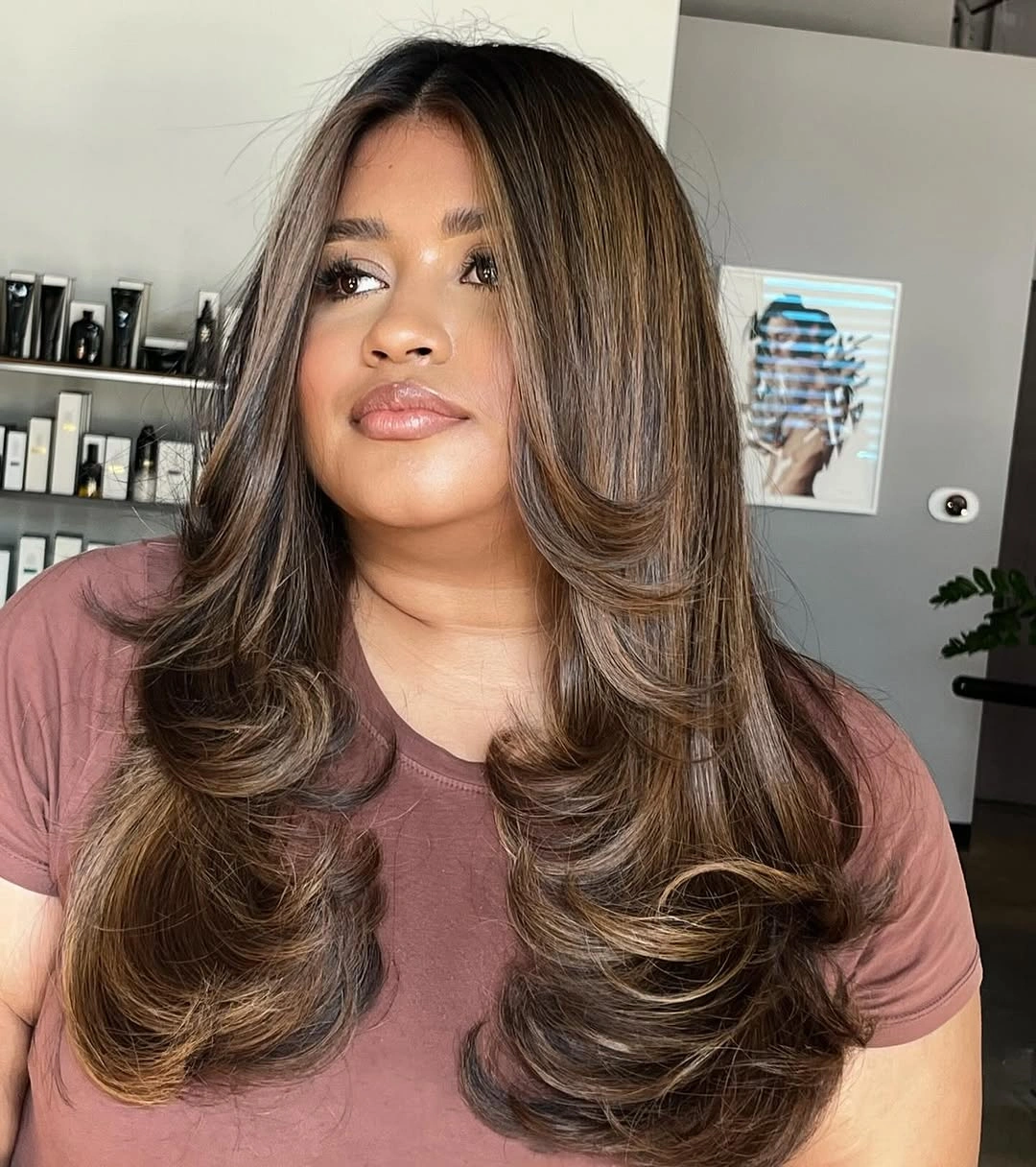 Long brown hair with prominent front layers and feathered ends