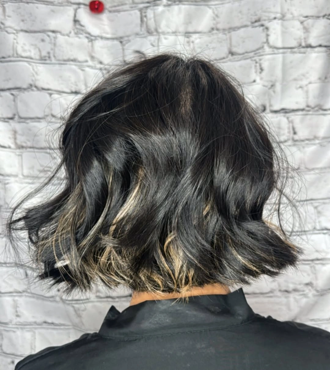 Dark wavy bob viewed from back with compact perimeter