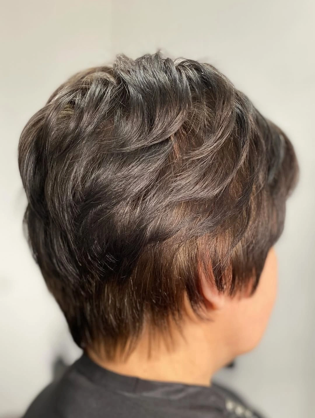 Dark brown textured pixie with broken crown and nape
