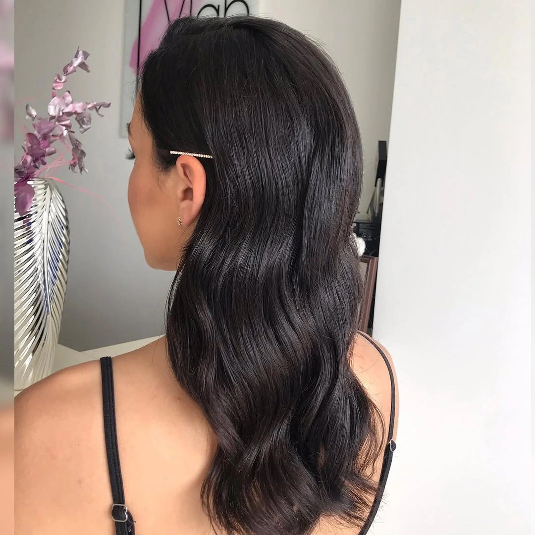 Long dark wavy hair with one side clipped back