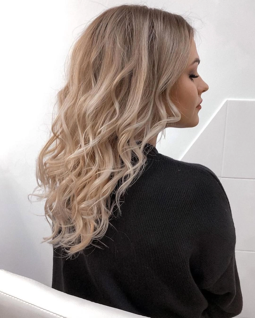 Light blonde medium-long hair with loose bends and curled ends